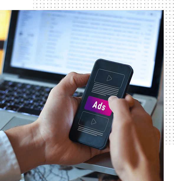 Advertising concept. A paid advertising agency manages a mobile phone and a laptop, using advertising software.